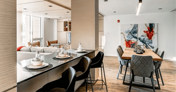 A modern dining room with a long table set for six.